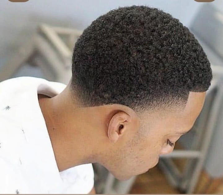 A clean taper on natural hair at GEE M'S Barbershop, Nairobi