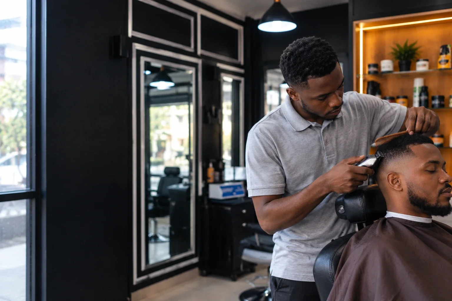 Barber giving a precision fade at GEE M'S, Nairobi